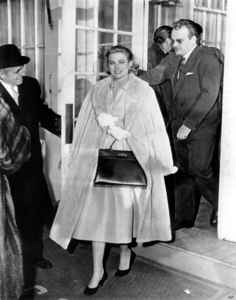 Grace Kelly with classic black handbag, exemplifying 1950s elegant fashion style