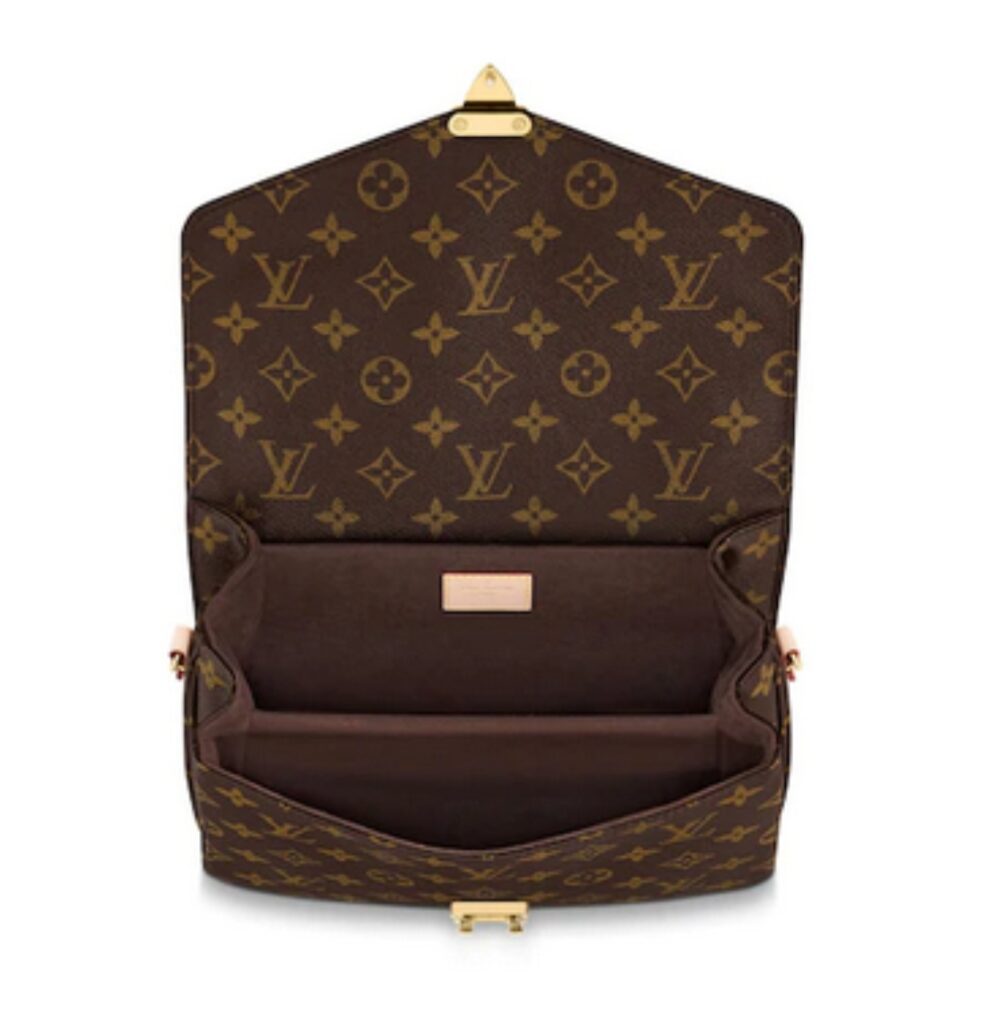 Open interior of Louis Vuitton monogram canvas bag, showcasing spacious compartment and brand details.