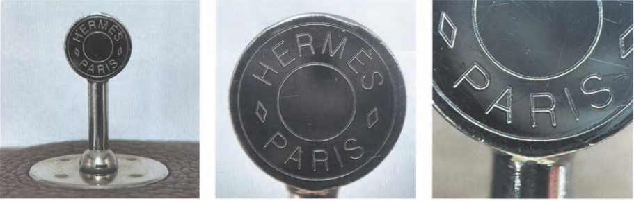 Close-up of authentic Hermès Kelly bag metal engraving hardware, showcasing precise "Hermès Paris" stamping on the lock and feet.
