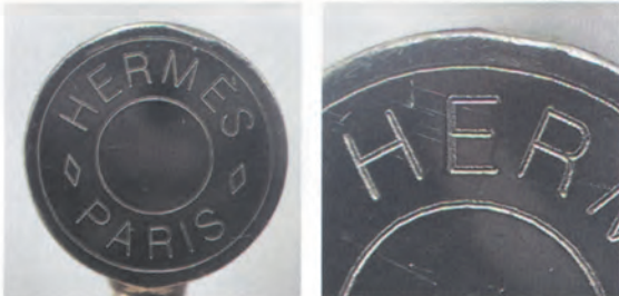 Authentic metal engraving on Hermès Kelly bag hardware, featuring sharp and evenly spaced "Hermès Paris" lettering.