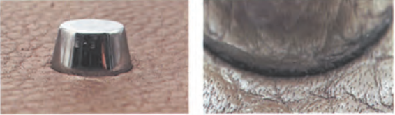 Authentic bottom studs on Hermès Kelly bag, showing rounded caps and secure attachment to leather.