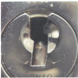 Hermès lock component – subtle metal texture and craftsmanship detail.