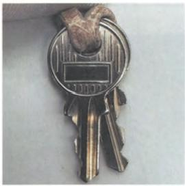 Hermès lock component – focus on shape, engraving, and metal finish.