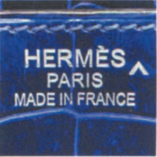 Hermès Porosus crocodile leather stamped with "HERMES PARIS MADE IN FRANCE" – premium exotic skin detail.
