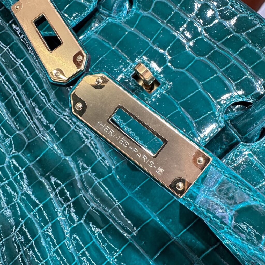 Close-up of the thick 24K gold plated sangle hardware and crisp Hermes Paris engraving on a bespoke Birkin 35 replica.