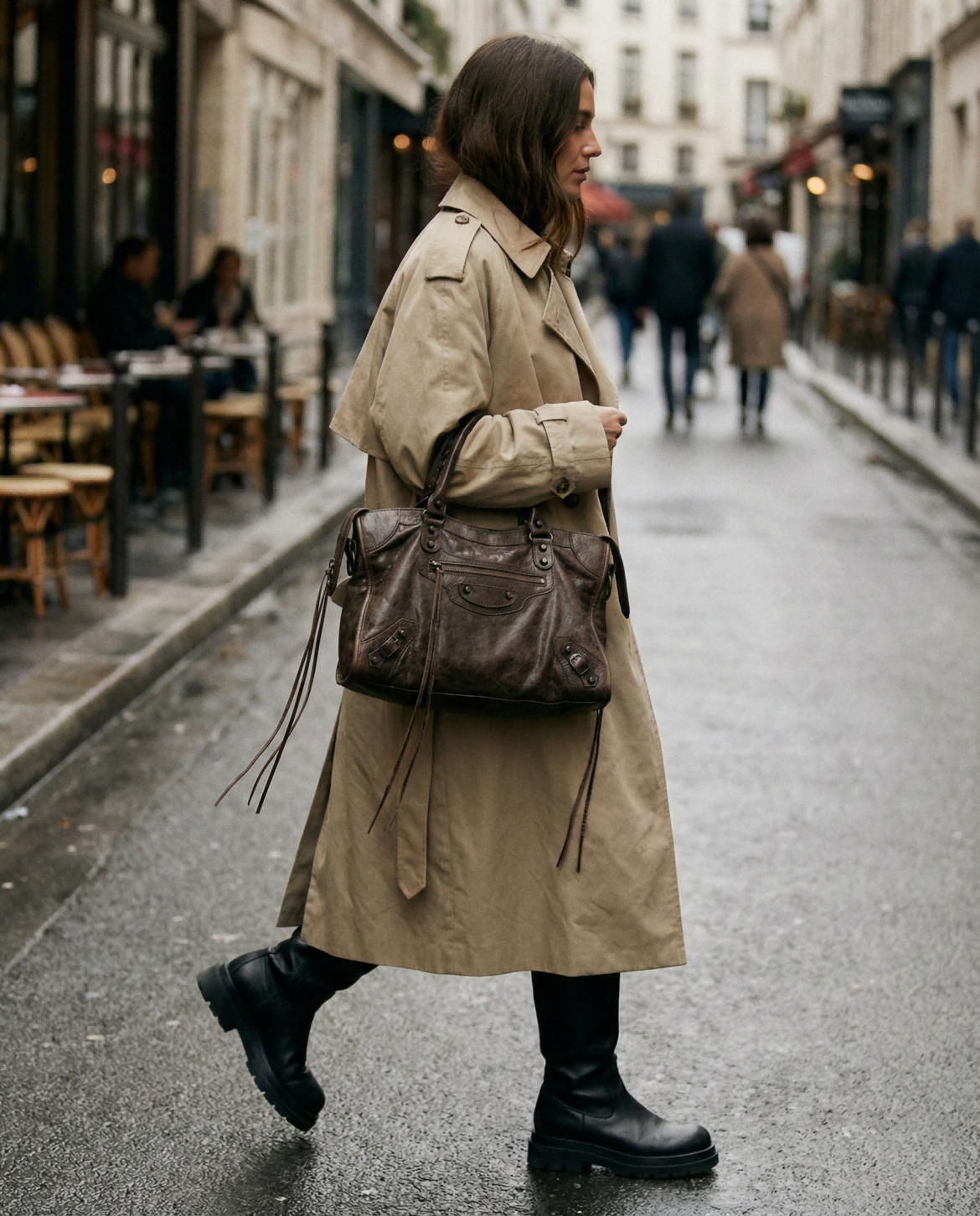 Street style fashion forecast 2026 showing a woman carrying an oversized, slouchy Dark Brown Balenciaga Le City replica bag with a trench coat.