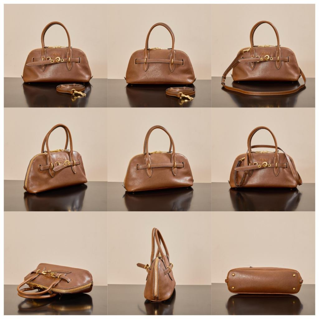 Cognac brown Miu Miu Beau/Aventure style replica bag with vintage gold belt buckle detail, grained leather texture, and top handle design.