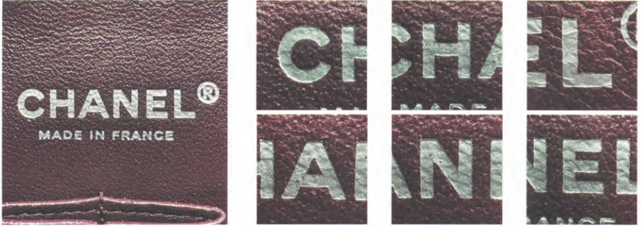 Authentic Chanel silver foil stamping on leather, displaying specific letter geometry like the flat-topped 'A' and shortened top 'H' crossbar.