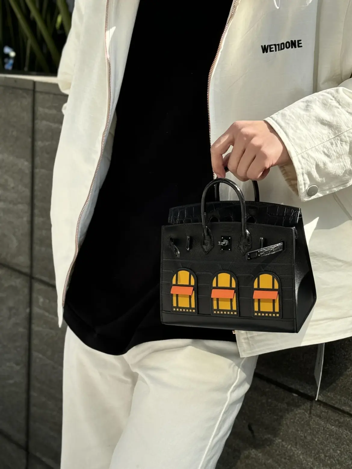 Birkin 20 Faubourg replica styled with a black top and cream jacket and trousers