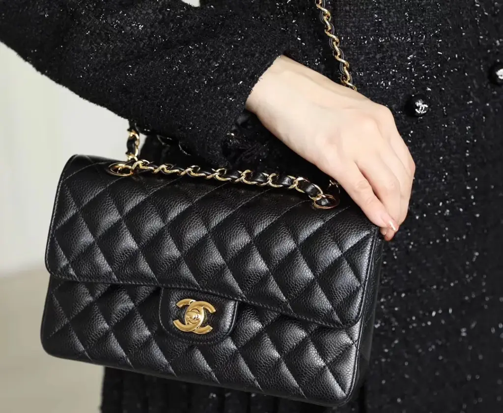 Close styling view of a black CF25 replica with warm gold hardware
