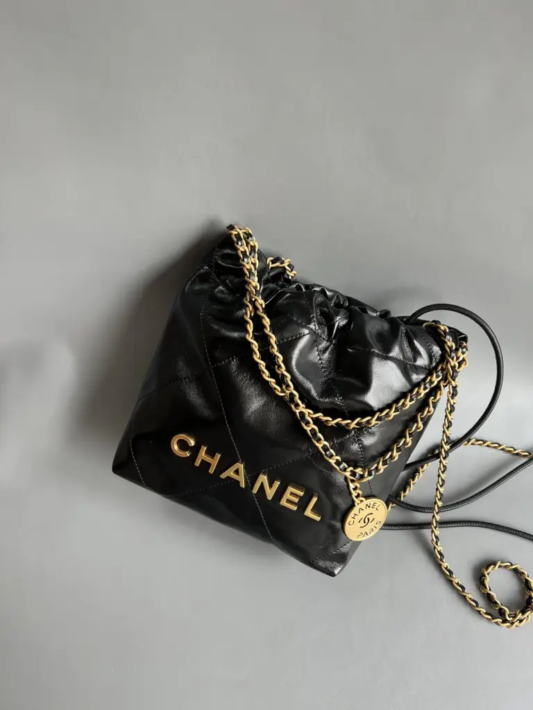Angled front view of the Chanel 22 Mini black gold bag