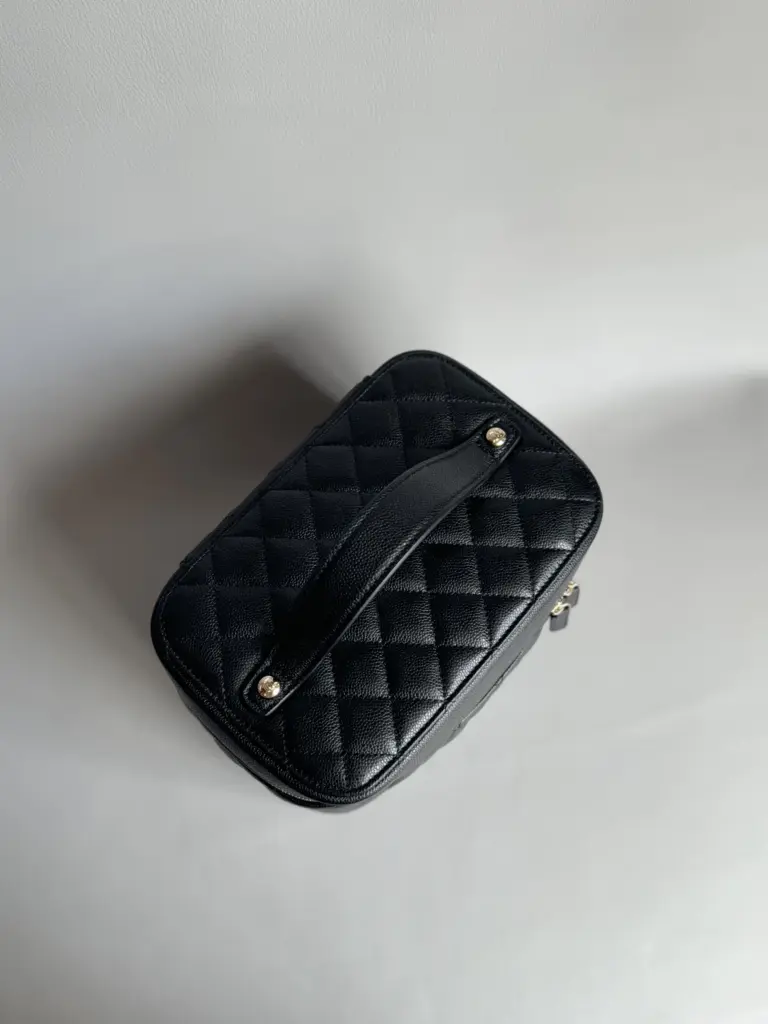 Top view of a Chanel vanity case replica with a centered leather handle