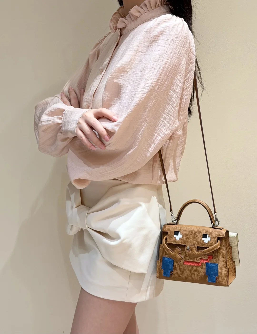 Side styling view of a Gold Kellydoll Picto 16.5 replica on a long shoulder strap
