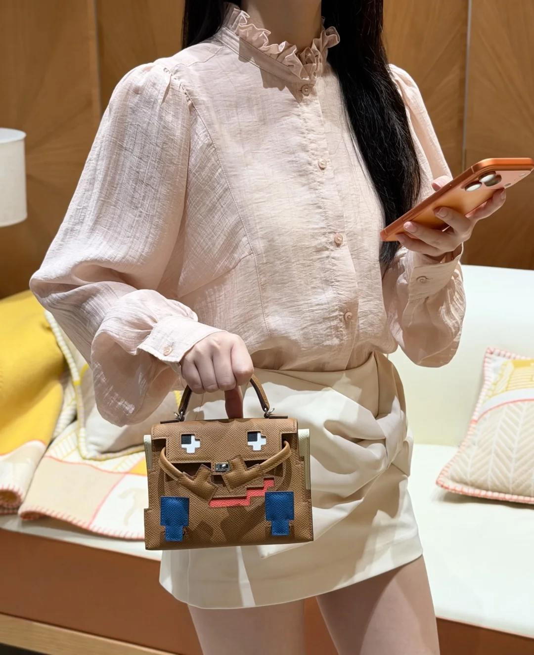 Full outfit view with the small bag carried by its top handle