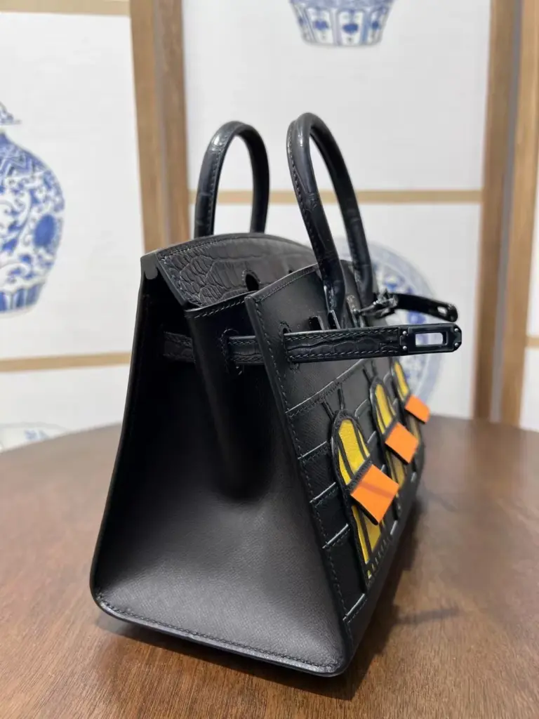 Left profile of a Birkin 20 Faubourg replica showing the triangular gusset