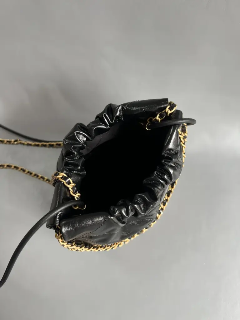 Open top view into the black Chanel 22 Mini-style bag