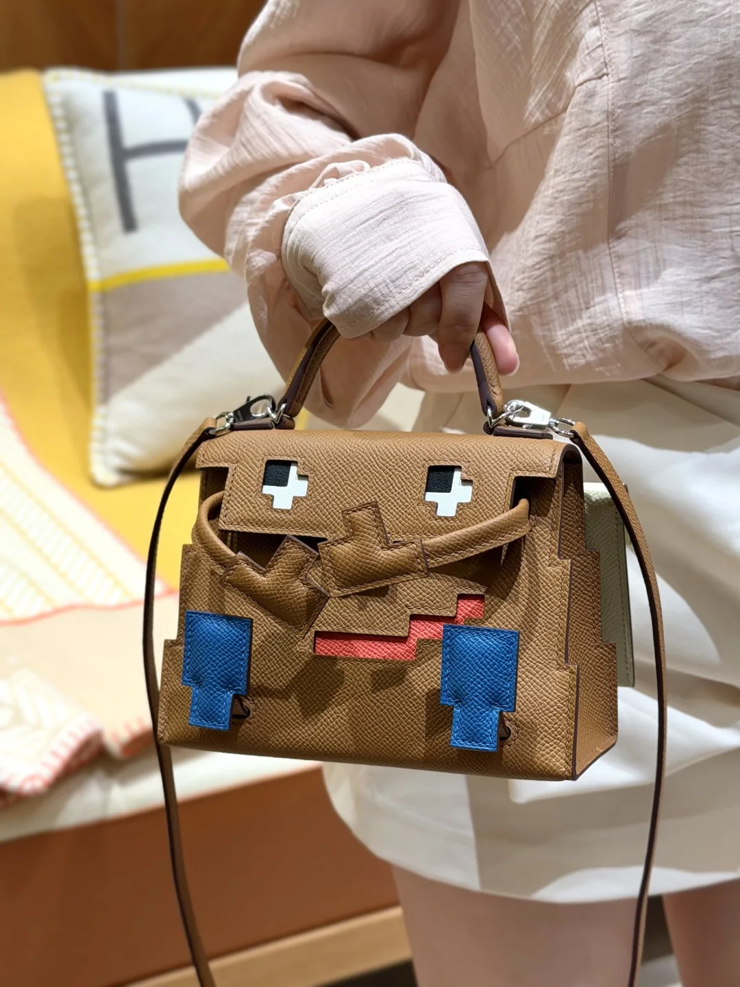 Close hand-carry view showing the pixel face and compact body