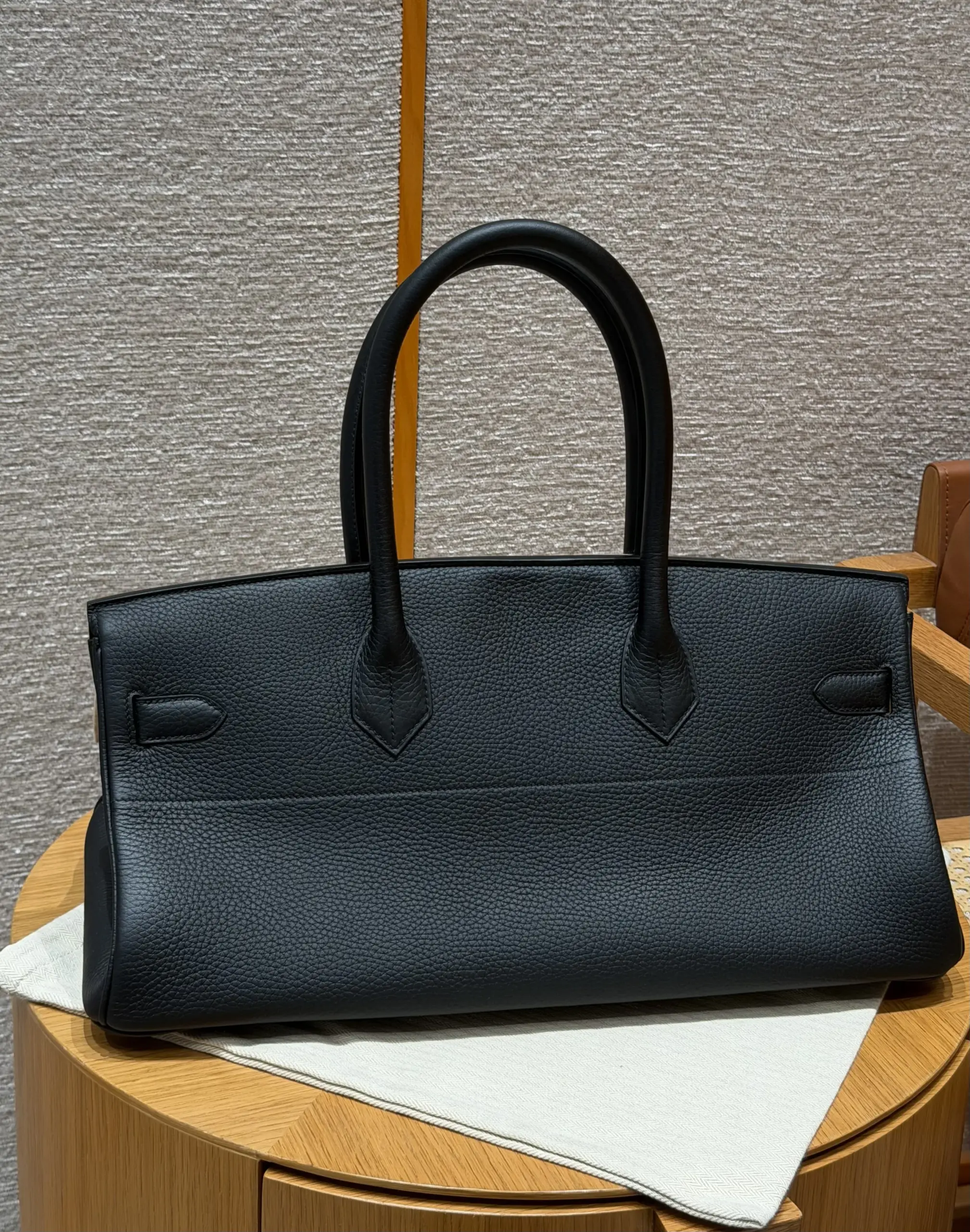 Back view of a black Shoulder Birkin 42 replica showing the horizontal panel seam and long handles