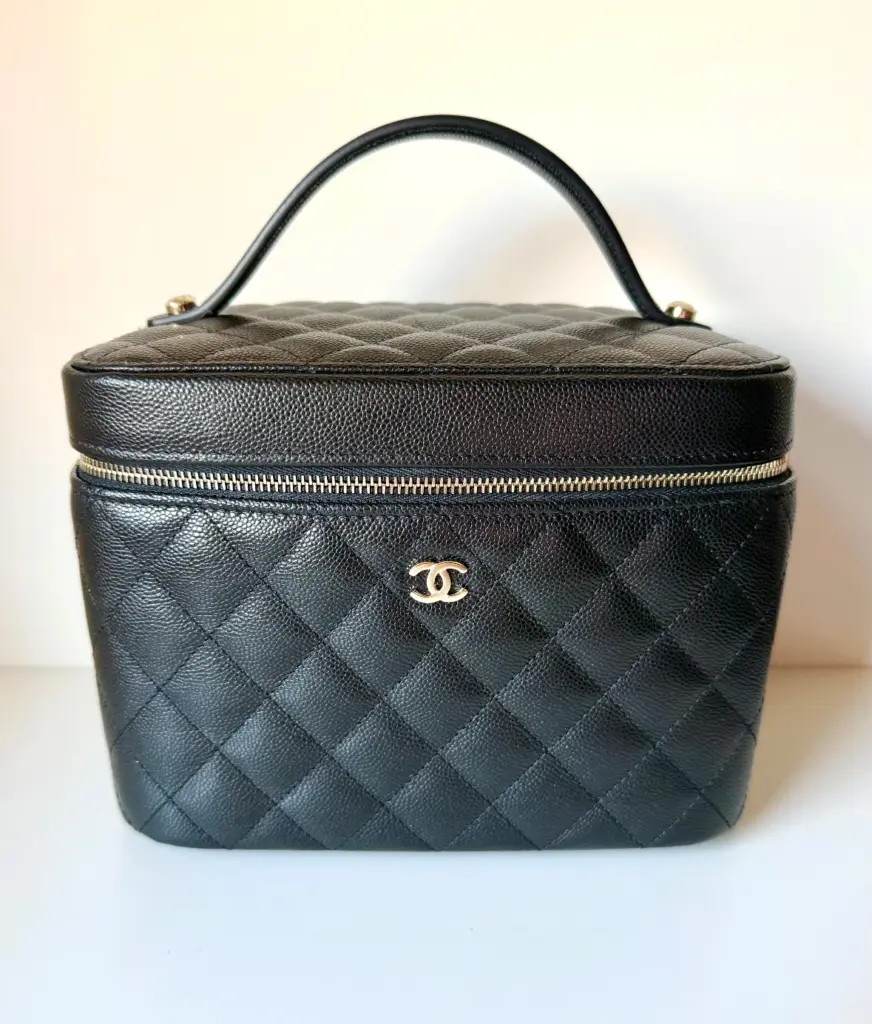 Straight-on front view of the black quilted vanity case