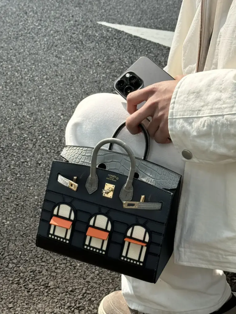 Birkin 20 Faubourg replica hand-carried with a black and cream outfit