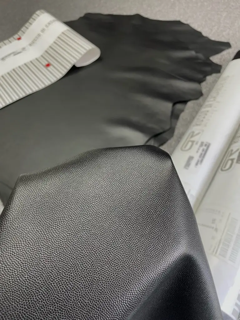Black caviar-style calfskin material reference showing pebble density