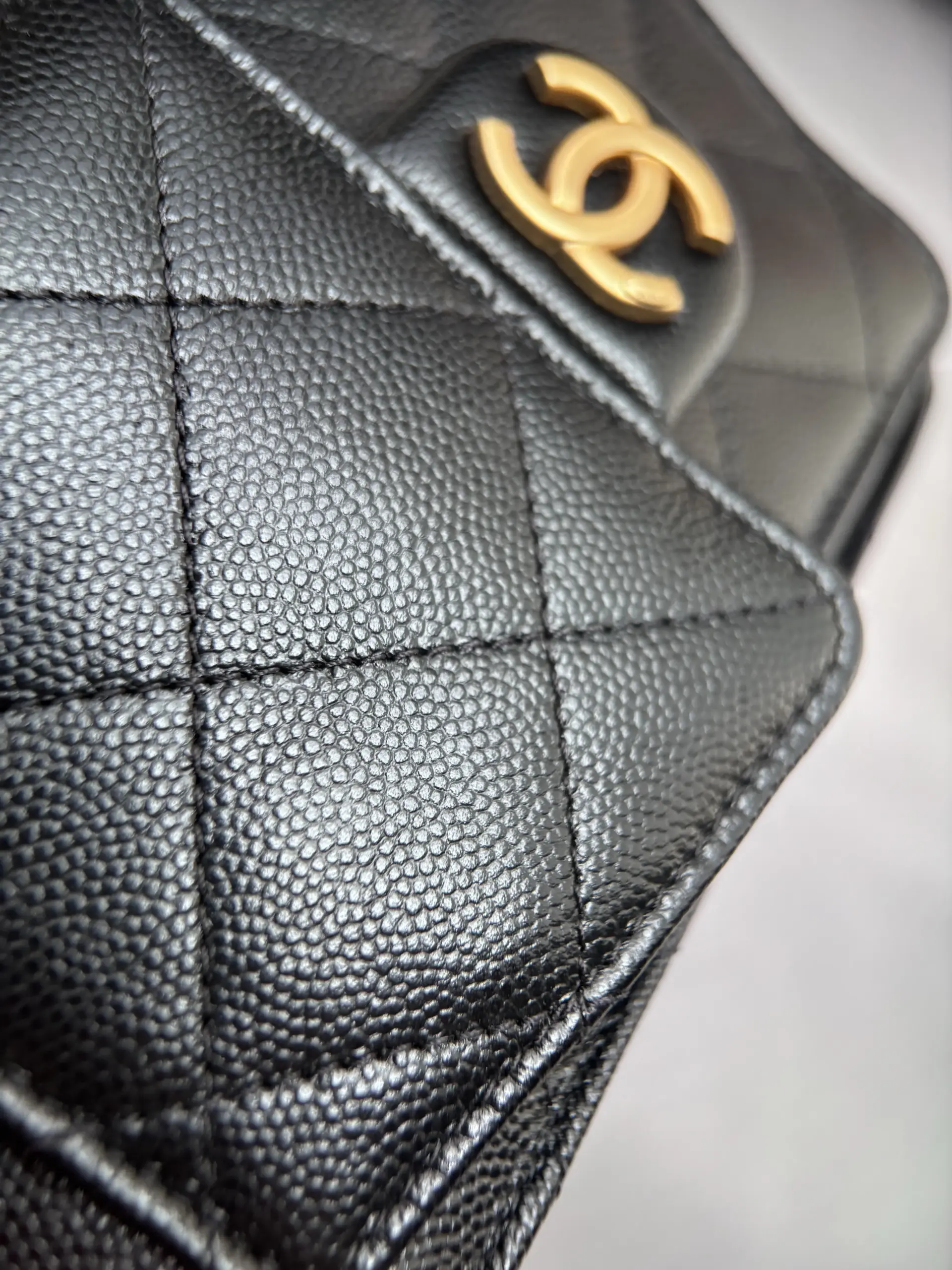 Chanel 25 Mini black gold side-pocket macro with fine caviar texture