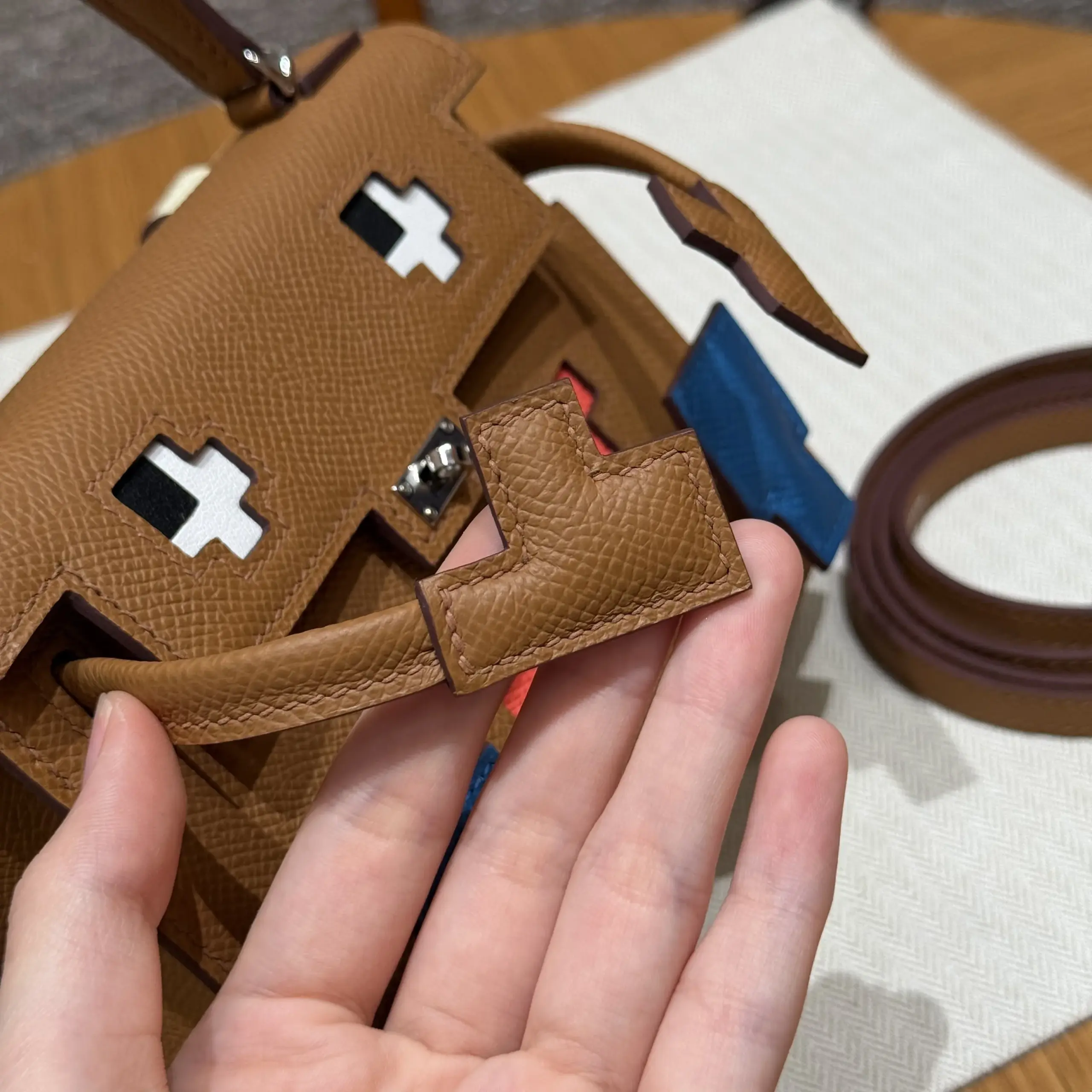 Macro view of the padded Gold arm tab and tonal stitching