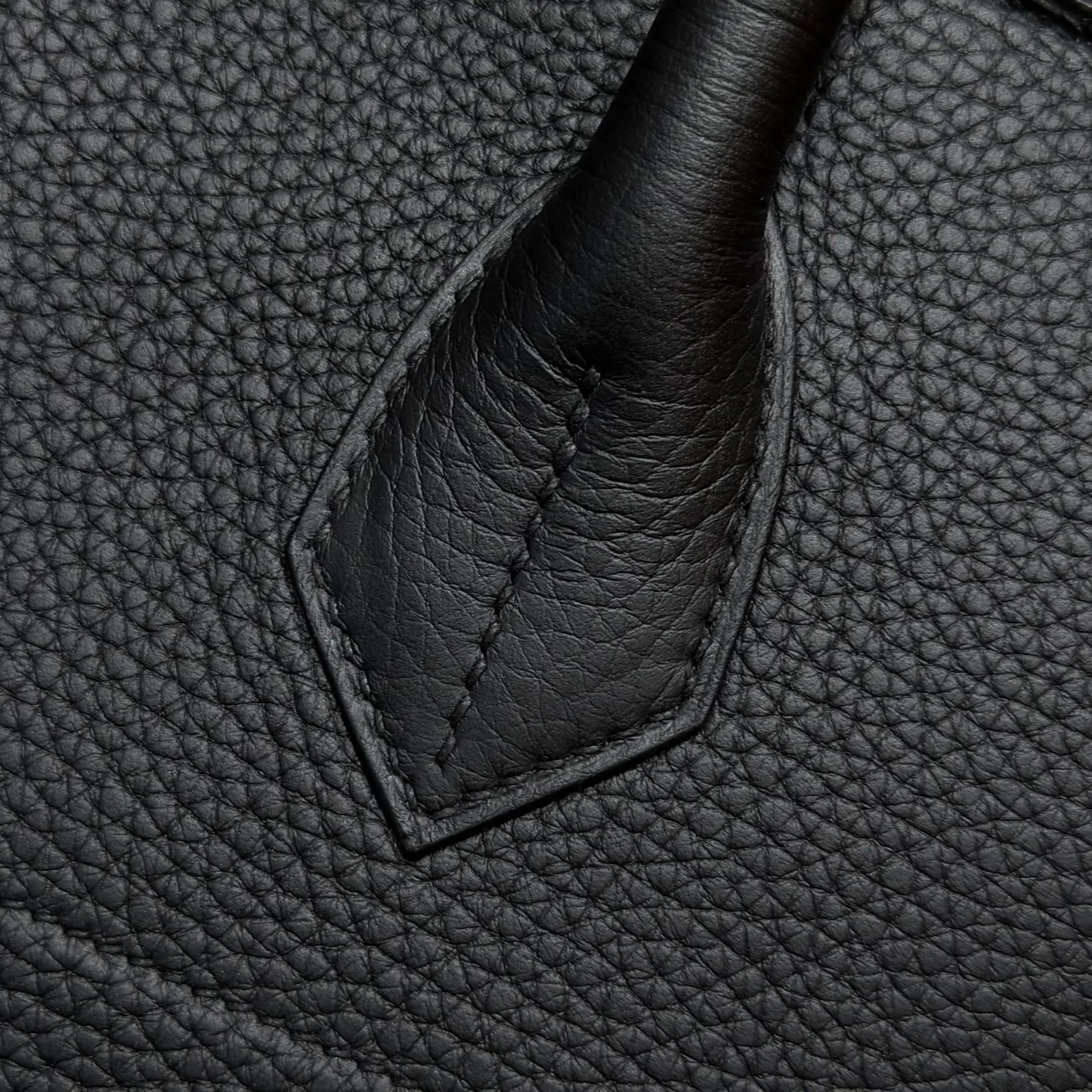 Macro view of one handle-base attachment on a black Shoulder Birkin 42 replica