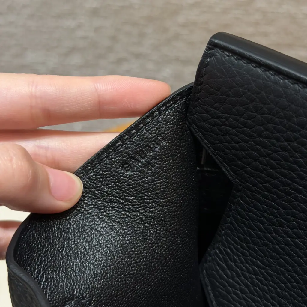 Macro view of a blind-stamp impression inside a black Shoulder Birkin 42 replica