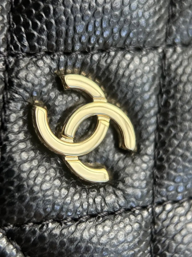 Front double-C emblem on black caviar quilting