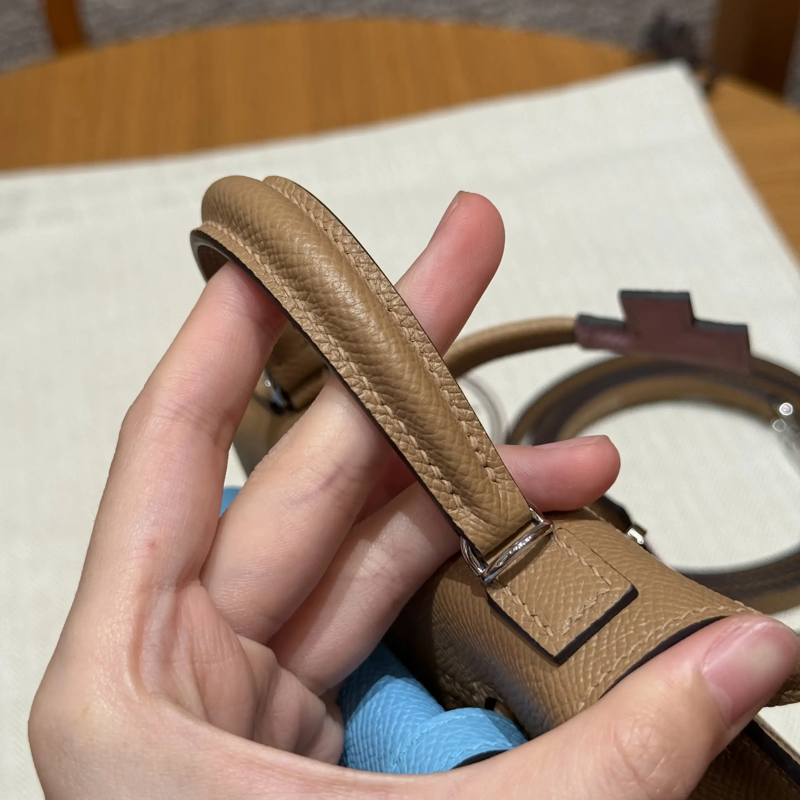 Close view of the padded top handle and tonal stitching