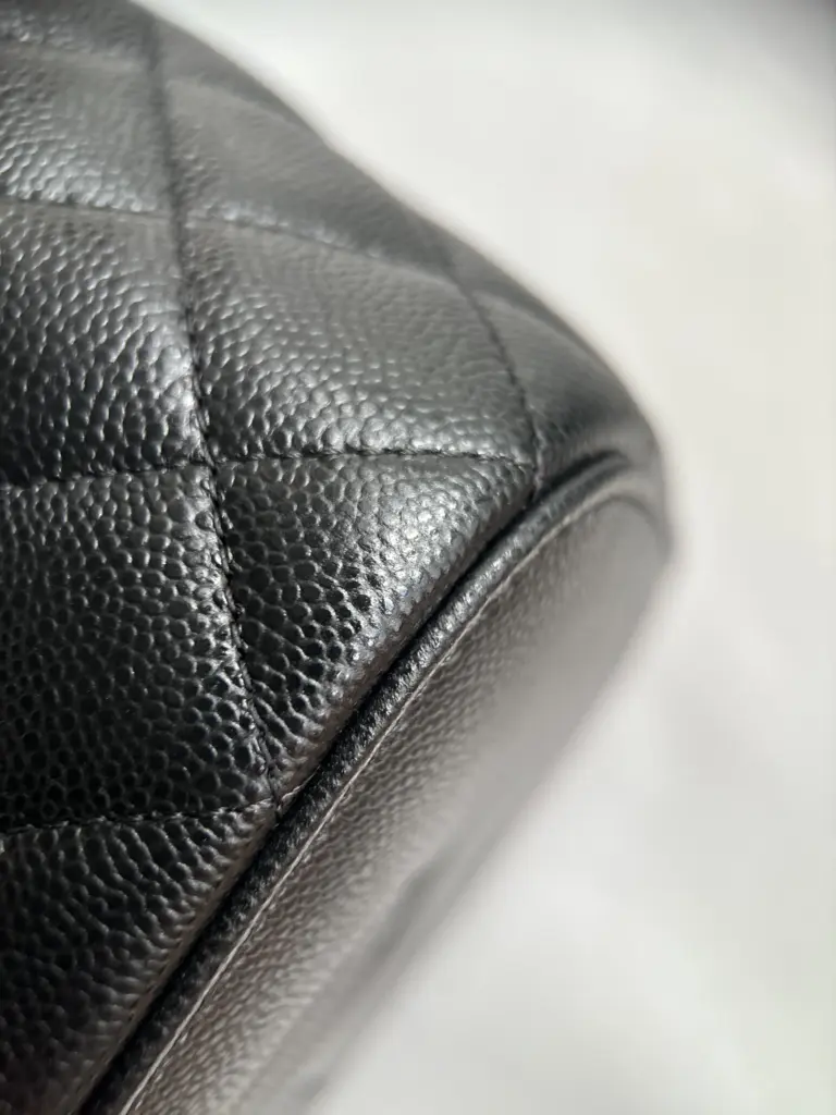 Macro of a black caviar vanity-case corner and edge finish