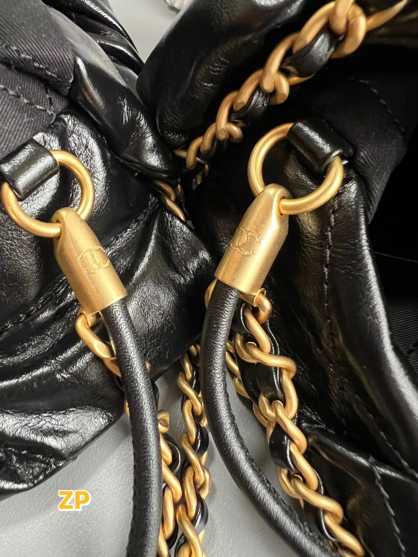 Authentic reference and reviewed gold-tone cord connectors with black leather cords