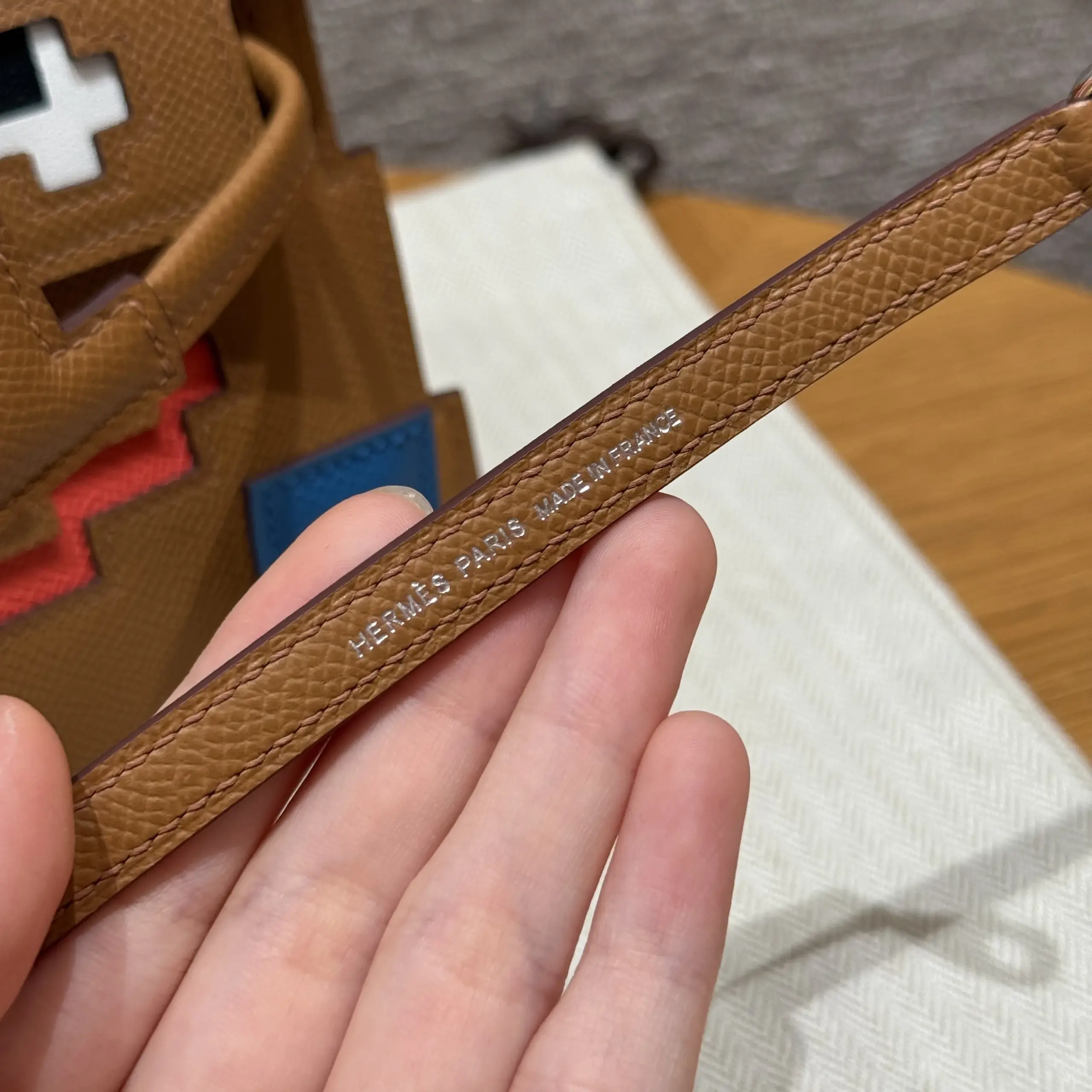 Second strap-mark view with pressed grain and tonal stitching