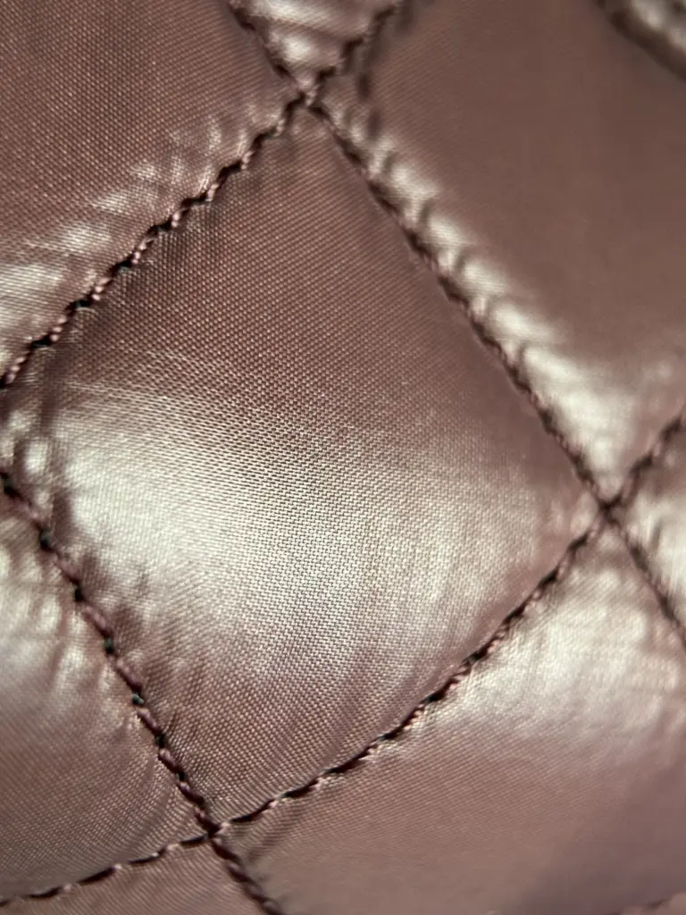 Mauve quilted interior lining and stitch detail