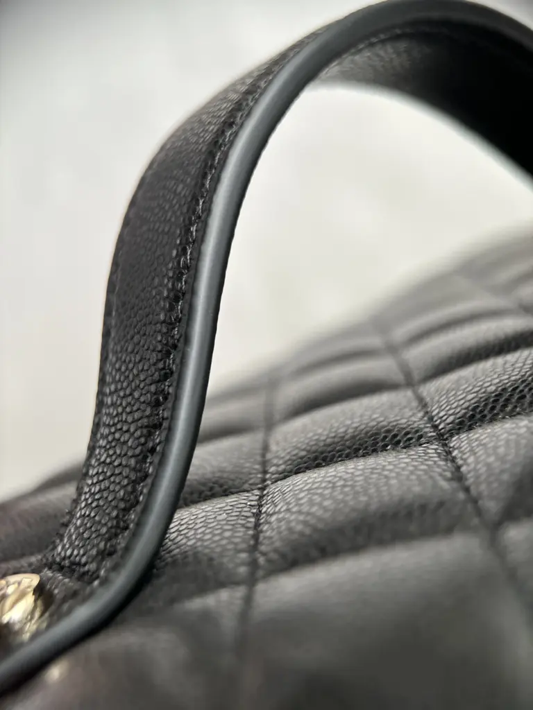 Close view of the leather handle edge and black edge paint