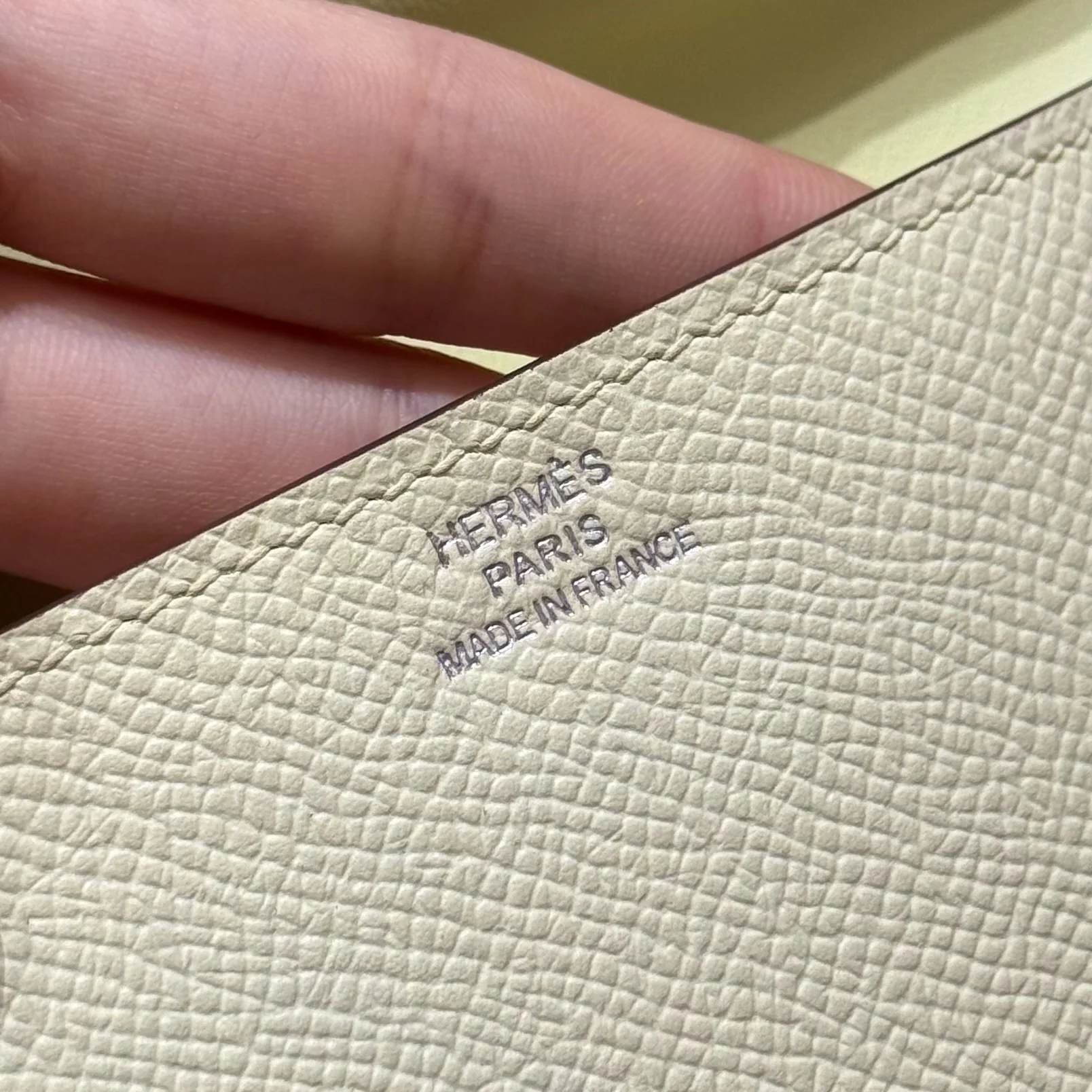 Macro view of the silver foil mark on the pale pouch