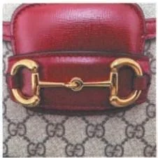 Gucci Horsebit closure photographed with its leather mount and adjacent canvas visible