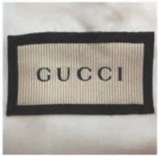 Front of a Gucci dust bag woven label photographed by Chloe