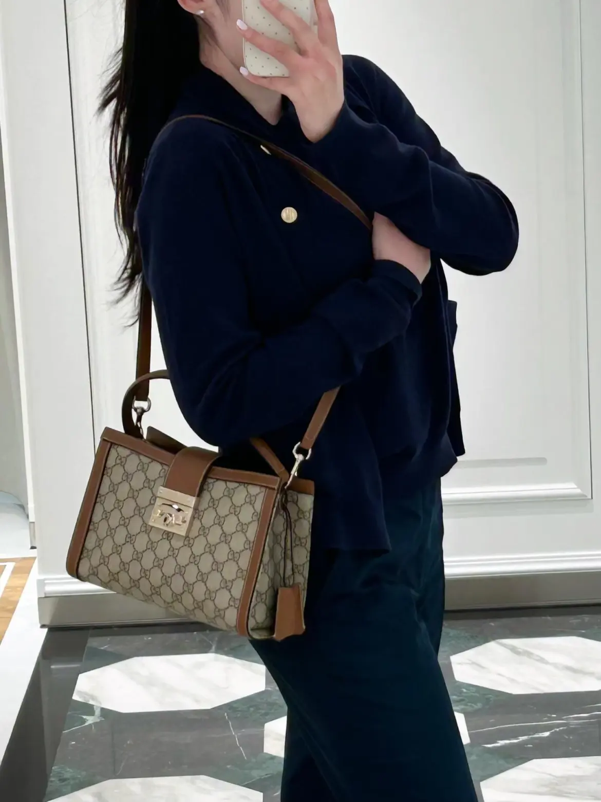 Gucci Padlock on the shoulder with a navy jacket and dark trousers