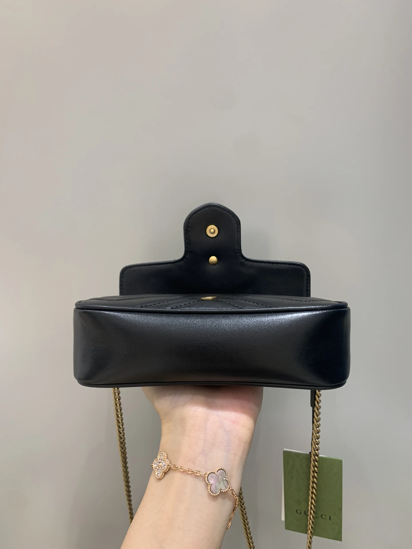GG Marmont smooth base held level with the flap open behind it