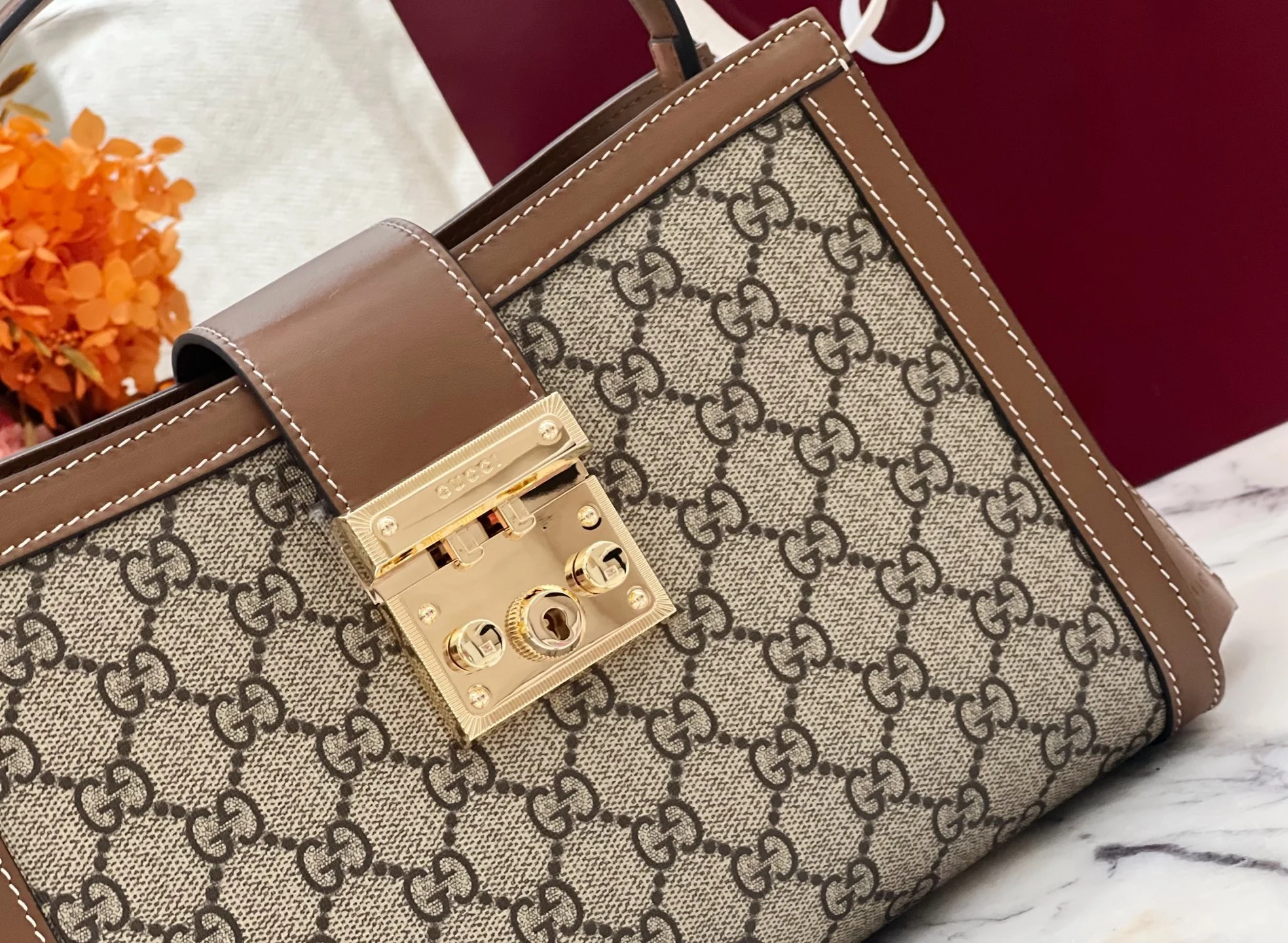 Gucci Padlock gold lock, central brown tab and contrast stitching