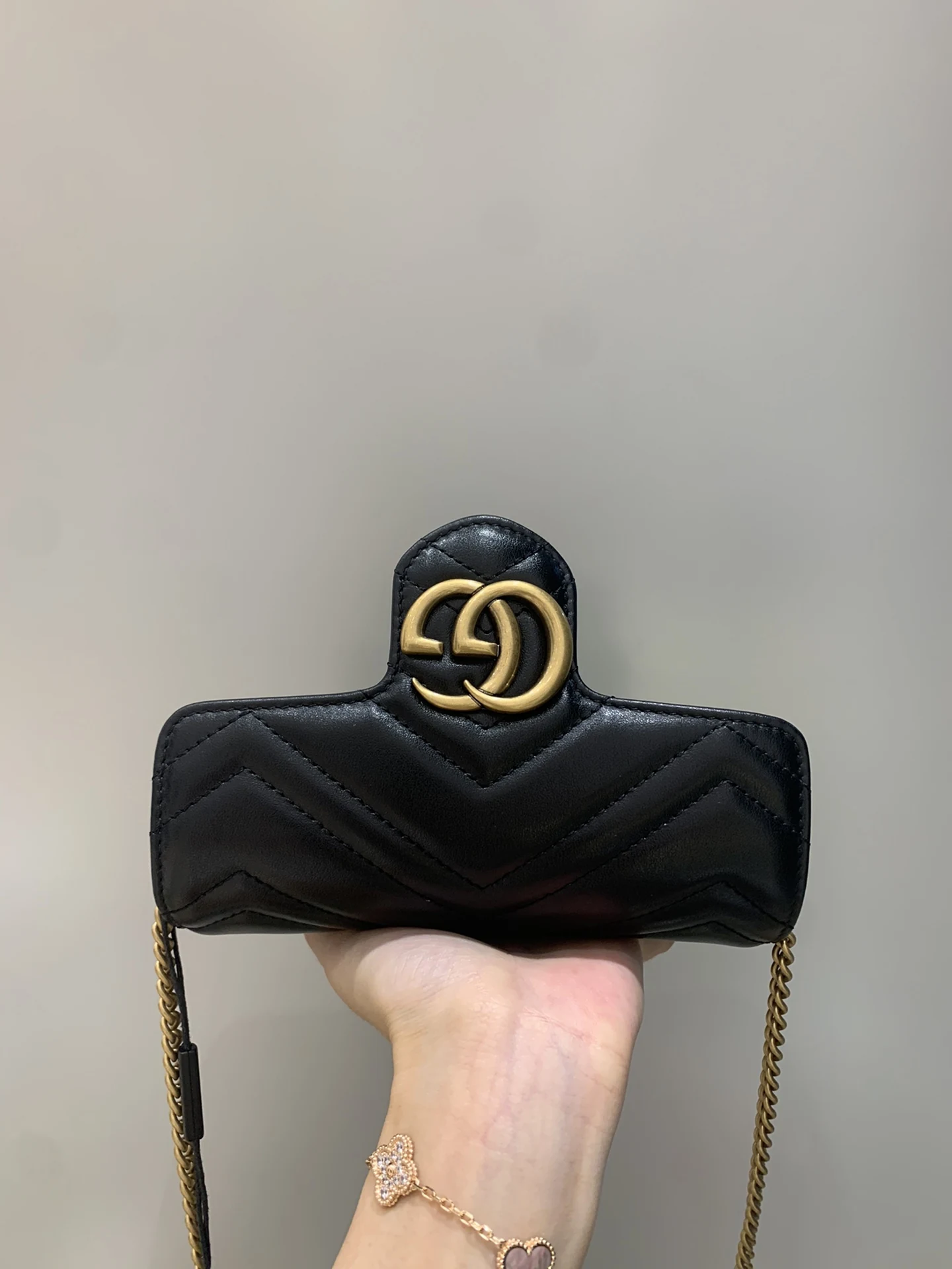 Warm gold Double G on the raised chevron-quilted flap