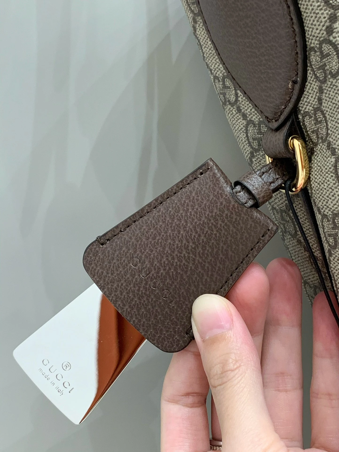 Reflective pull-out mirror in a brown side holder