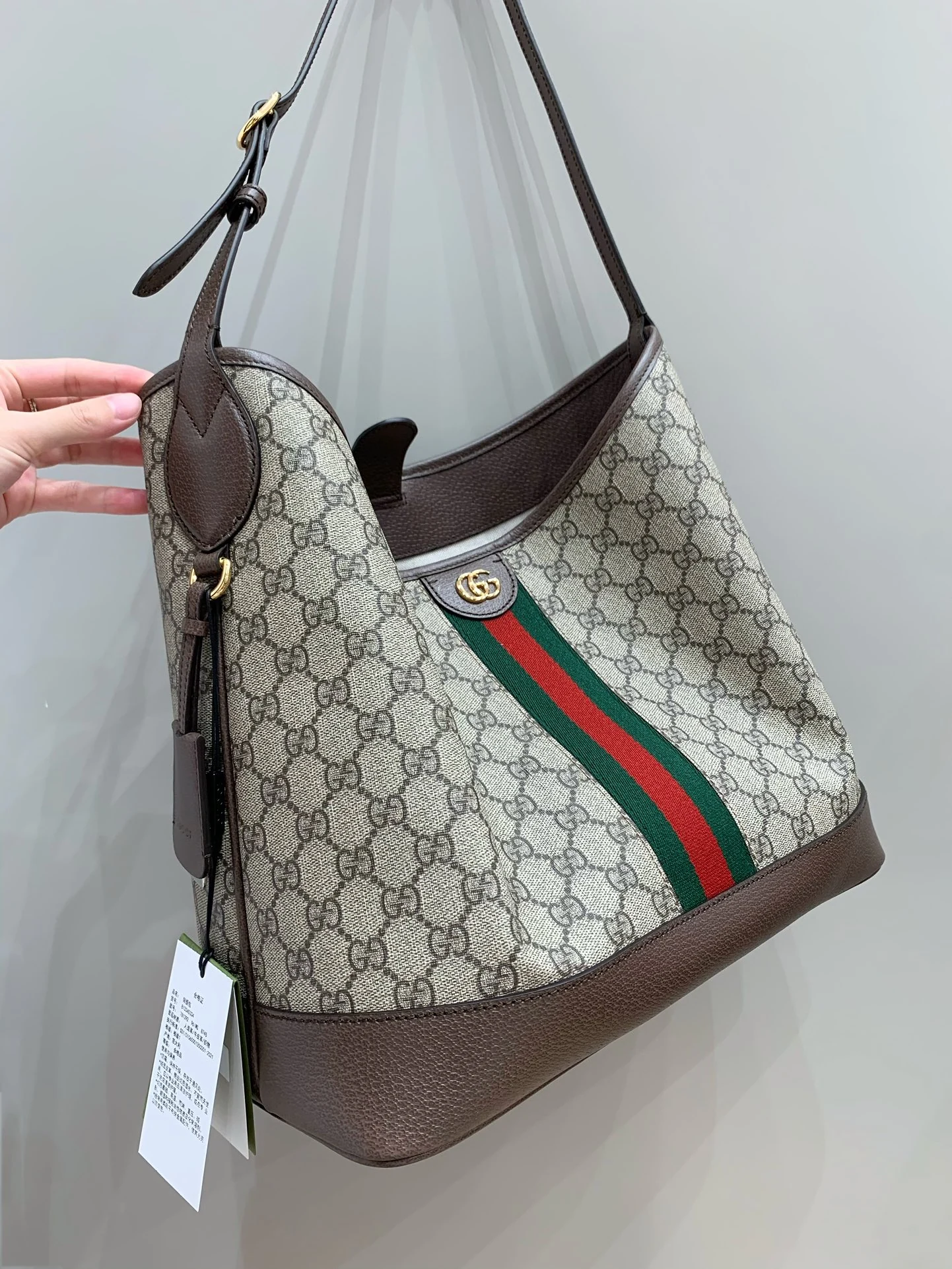 Angled monogram bag with a soft fold across its front