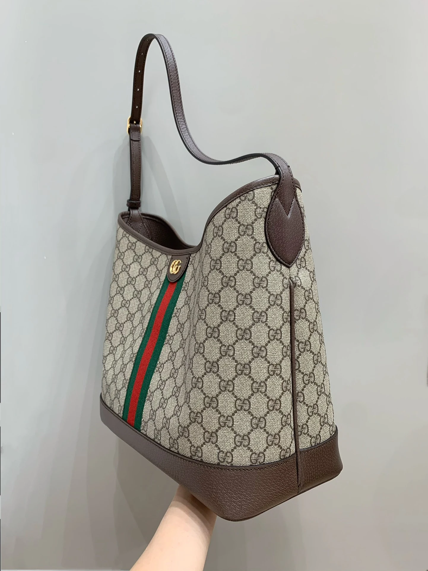 Opposite side of the bag with a vertical seam and brown strap patch